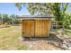 Wooden shed on a grassy lot, perfect for outdoor storage at 6821 Mary Lou Ln, Wesley Chapel, FL 33544