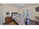 Inviting bedroom featuring a private balcony, complemented by wood floors and warm decor at 6822 Kissimmee St # 8-B, Tampa, FL 33616