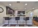 Charming kitchen area featuring granite countertops, barstool seating, and stainless appliances at 6822 Kissimmee St # 8-B, Tampa, FL 33616