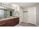 Bathroom featuring double sinks, granite countertops, and a walk-in shower for a luxurious experience at 7202 Ozello Trail Ave, Ruskin, FL 33573