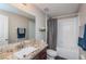 Bathroom features granite countertops, neutral tones, and a shower and tub combination at 7202 Ozello Trail Ave, Ruskin, FL 33573