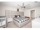 Modern bedroom with stylish headboard, ceiling fan, and coordinated furniture creates a relaxing retreat at 7202 Ozello Trail Ave, Ruskin, FL 33573