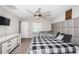 Modern bedroom with stylish headboard, ceiling fan, and coordinated furniture creates a relaxing retreat at 7202 Ozello Trail Ave, Ruskin, FL 33573