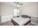 This bedroom features a ceiling fan, dresser, and additional shelving providing ample storage space at 7202 Ozello Trail Ave, Ruskin, FL 33573
