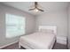 Bright bedroom featuring a ceiling fan, large window, and neutral tones for a relaxing atmosphere at 7202 Ozello Trail Ave, Ruskin, FL 33573