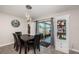 Bright dining area features modern chandelier, stylish cabinets and outdoor view through sliding glass door at 7202 Ozello Trail Ave, Ruskin, FL 33573