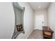 Bright foyer with tile flooring, a decorative mirror, and a lovely entryway table at 7202 Ozello Trail Ave, Ruskin, FL 33573