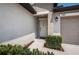 Welcoming front entrance with a covered porch, a white front door, and an attached garage at 7202 Ozello Trail Ave, Ruskin, FL 33573