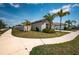 Inviting single-story home featuring lush landscaping and a two car garage at 7202 Ozello Trail Ave, Ruskin, FL 33573