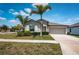 Charming single-story home featuring a well-manicured lawn and a two car garage at 7202 Ozello Trail Ave, Ruskin, FL 33573