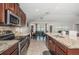 Modern kitchen with granite countertops, stainless appliances, and an open concept design at 7202 Ozello Trail Ave, Ruskin, FL 33573