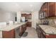 Spacious kitchen with granite countertops, stainless steel appliances, and tile flooring at 7202 Ozello Trail Ave, Ruskin, FL 33573