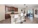 Well-lit kitchen featuring granite countertops, a breakfast bar, and modern appliances at 7202 Ozello Trail Ave, Ruskin, FL 33573