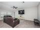 Comfortable living room with tile floors, a ceiling fan, and a mounted TV for relaxation at 7202 Ozello Trail Ave, Ruskin, FL 33573