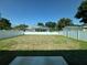 Large backyard with a privacy fence and view of a screened in pool at 7208 N Glen Ave, Tampa, FL 33614