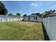 Spacious backyard features lush green grass and is enclosed by a new white privacy fence at 7208 N Glen Ave, Tampa, FL 33614