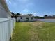 Spacious backyard features lush green grass and is enclosed by a new white privacy fence at 7208 N Glen Ave, Tampa, FL 33614