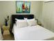 Cozy bedroom with a comfortable bed, stylish decor, and ample closet space at 7208 N Glen Ave, Tampa, FL 33614