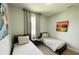 Inviting bedroom featuring two twin beds, simple decor and natural light from the window at 7208 N Glen Ave, Tampa, FL 33614