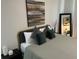 Modern bedroom with grey and white linens, accent pillows, and minimalist decor at 7208 N Glen Ave, Tampa, FL 33614