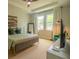 Cozy bedroom featuring a bed with stylish linens, decor, and abundant natural light at 7208 N Glen Ave, Tampa, FL 33614