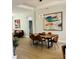 Open-concept dining area featuring a large table, modern decor, and ample seating at 7208 N Glen Ave, Tampa, FL 33614