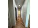 Hallway with appealing herringbone-patterned wood flooring, recessed lights, and white trim at 7208 N Glen Ave, Tampa, FL 33614
