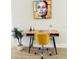 Bright home office with modern desk, stylish chair, and vibrant artwork at 7208 N Glen Ave, Tampa, FL 33614