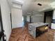 Bright kitchen with a marble island, custom cabinets, and herringbone floors, seamlessly integrated at 7208 N Glen Ave, Tampa, FL 33614