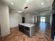 A kitchen island with granite countertop and stainless steel microwave with hardwood flooring at 7208 N Glen Ave, Tampa, FL 33614