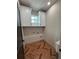 Bright laundry room boasts a modern herringbone floor and clean, white cabinetry for ample storage at 7208 N Glen Ave, Tampa, FL 33614
