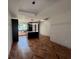 Open-concept living space with Herringbone floors, large windows, and stylish light fixtures at 7208 N Glen Ave, Tampa, FL 33614