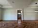 Open living room with hardwood flooring, and view of a bathroom and backyard at 7208 N Glen Ave, Tampa, FL 33614