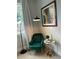 Bright living room with reading nook, modern art, and a green velvet chair at 7208 N Glen Ave, Tampa, FL 33614
