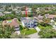 Aerial view of a home in a residential neighborhood with mature trees and landscaping at 750 Sand Pine Ne Dr, St Petersburg, FL 33703