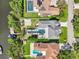 Aerial view of a home featuring a backyard pool, basketball court, and lush landscaping at 750 Sand Pine Ne Dr, St Petersburg, FL 33703
