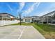 Spacious backyard featuring a basketball court, pool and screened-in patio area at 750 Sand Pine Ne Dr, St Petersburg, FL 33703