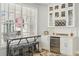 Stylish bar with white cabinets, mini fridge, and seating with views at 750 Sand Pine Ne Dr, St Petersburg, FL 33703