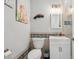 Bathroom featuring tiled walls, decorative artwork, and white vanity at 750 Sand Pine Ne Dr, St Petersburg, FL 33703