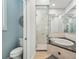 Well-lit bathroom showcasing walk-in shower, luxurious soaking tub, and toilet in a separate room at 750 Sand Pine Ne Dr, St Petersburg, FL 33703