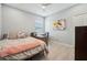 Cozy bedroom featuring a comfortable bed, desk, and a closet offering a simple, clean living space at 750 Sand Pine Ne Dr, St Petersburg, FL 33703