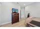 Comfortable bedroom featuring a wooden dresser with a television and a bright, airy atmosphere at 750 Sand Pine Ne Dr, St Petersburg, FL 33703