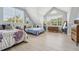 Bright bedroom featuring multiple windows, two beds, and neutral-toned flooring for a cozy, airy feel at 750 Sand Pine Ne Dr, St Petersburg, FL 33703