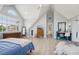 Large bedroom under a vaulted ceiling featuring two beds, a ceiling fan, and modern decor and light-colored flooring at 750 Sand Pine Ne Dr, St Petersburg, FL 33703