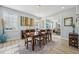 Formal dining area boasts a wooden table, chandelier lighting, large windows, and access to a sun-filled living space at 750 Sand Pine Ne Dr, St Petersburg, FL 33703