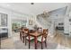 Well-lit dining room showcases a wooden table, view to the staircase, and open access to the living room at 750 Sand Pine Ne Dr, St Petersburg, FL 33703