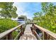 Waterfront property features a private wooden dock for boating and enjoying scenic views at 750 Sand Pine Ne Dr, St Petersburg, FL 33703