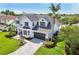 Elegant two-story home boasts a well-manicured lawn and an attached two-car garage at 750 Sand Pine Ne Dr, St Petersburg, FL 33703