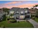 Elegant two-story home with lush lawn, manicured landscaping and paver driveway at 750 Sand Pine Ne Dr, St Petersburg, FL 33703