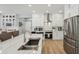Stylish kitchen with white cabinets, marble countertops, stainless steel appliances, and a herringbone backsplash at 750 Sand Pine Ne Dr, St Petersburg, FL 33703